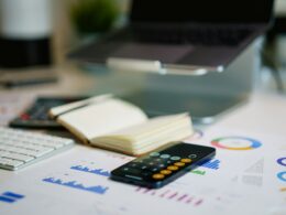 Office desk with financial charts and a calculator