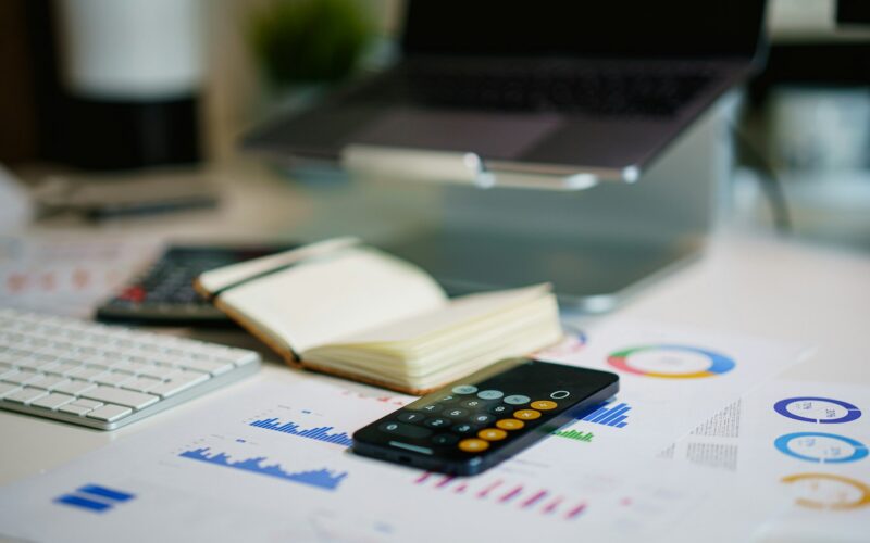 Office desk with financial charts and a calculator