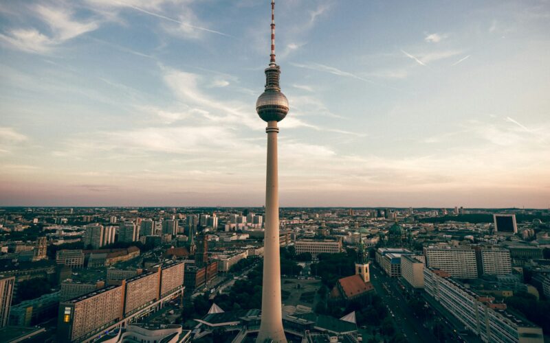 Berlin's Fernsehturm television tower rising above the city skyline at dusk