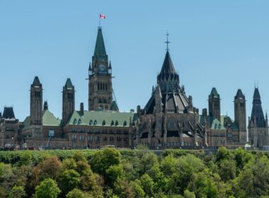 Parliament building with a clock tower against a cloudy sky