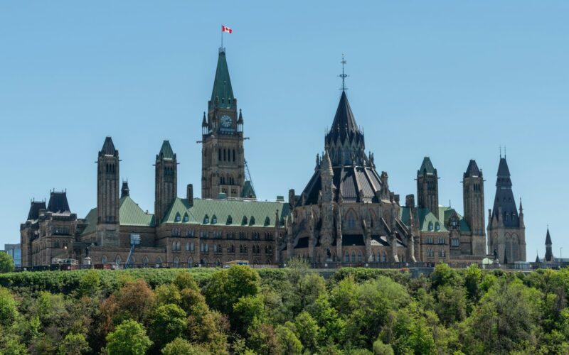 Parliament building with a clock tower against a cloudy sky