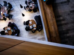 Overhead view of staff working at open plan office desks