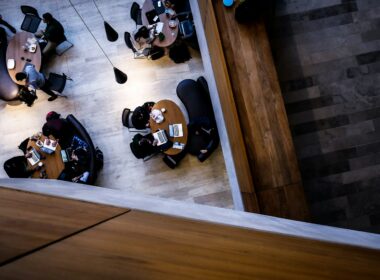 Overhead view of staff working at open plan office desks