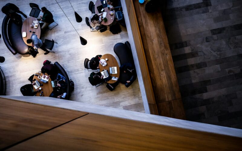 Overhead view of staff working at open plan office desks