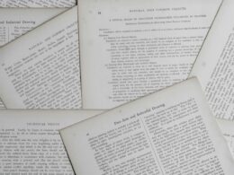 Stack of printed policy documents on a desk