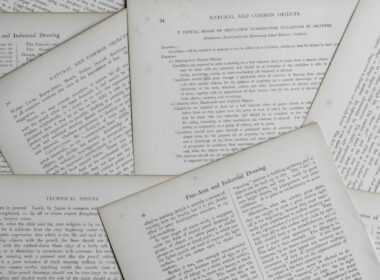 Stack of printed policy documents on a desk