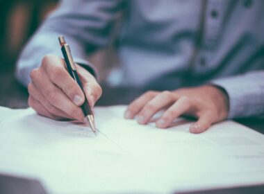 Executive signing a software contract at a desk