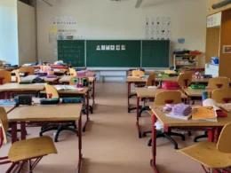 A classroom filled with lots of desks and chairs