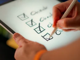 A hand marks off items on a checklist