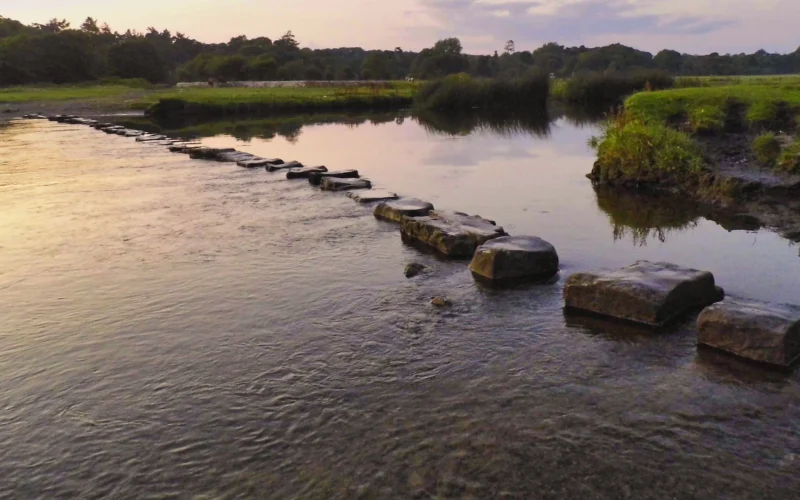 A line of stepping stones sitting in the middle of a river