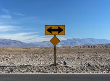 A road sign pointing in opposite directions in the desert