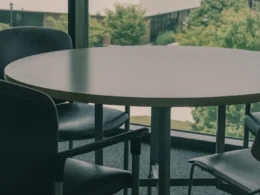 A table and chairs in front of a large window