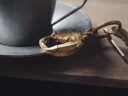 Keys on a wooden table beside a cup, a reminder that third-party AI agents need their own access keys