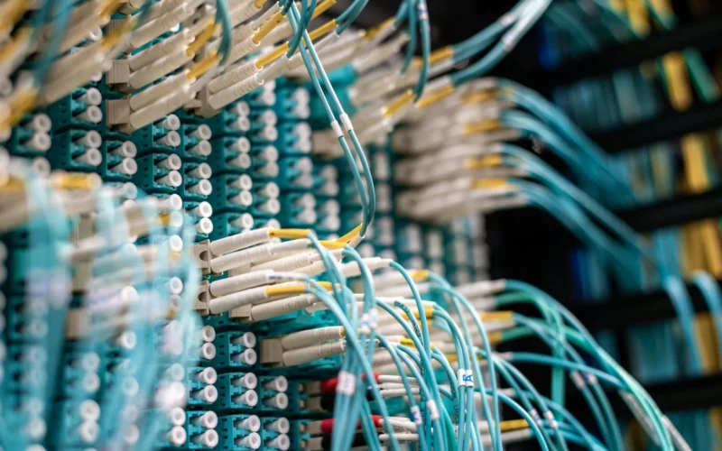 Fibre optic cables plugged into a patch panel in a data centre.