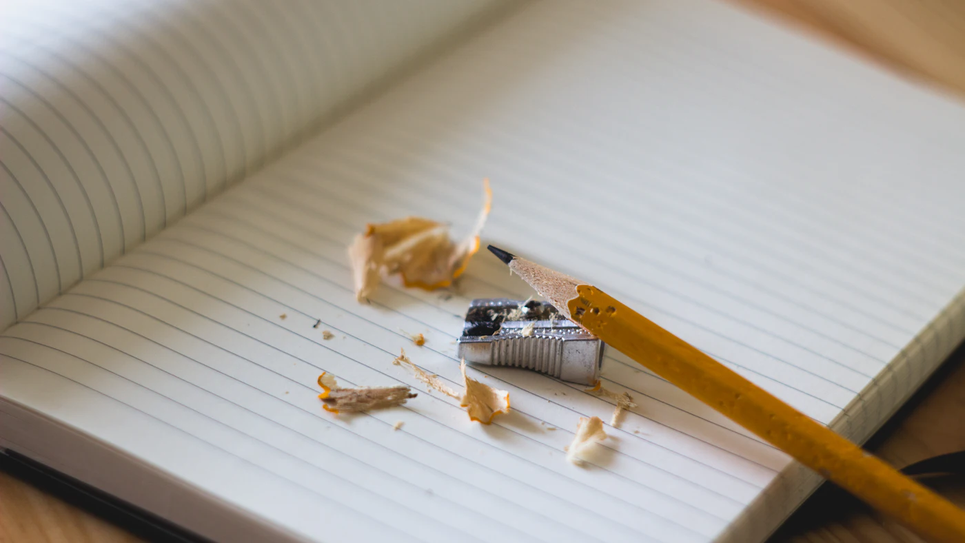 A pencil and sharpener on a notebook page