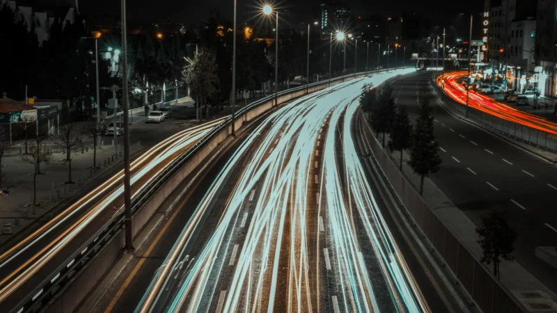 Light trails from traffic on a city highway at night