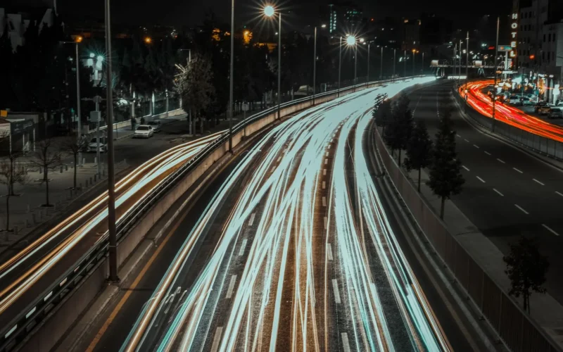 Light trails from traffic on a city highway at night