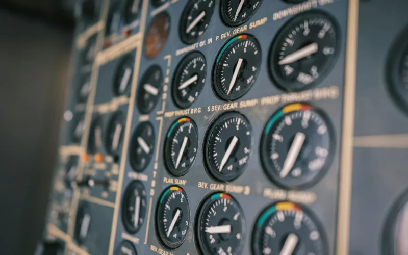 Close-up of an aircraft cockpit instrument panel with dials and switches
