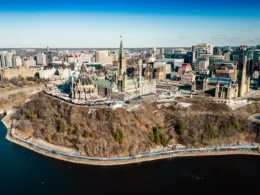 An aerial view of a city with a lake in the foreground