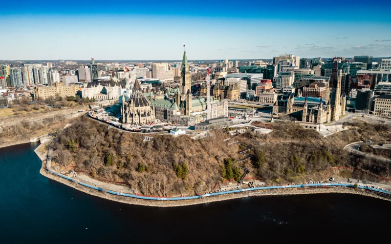 An aerial view of a city with a lake in the foreground