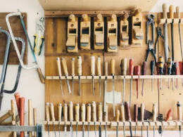 Assorted handheld tools in tool rack