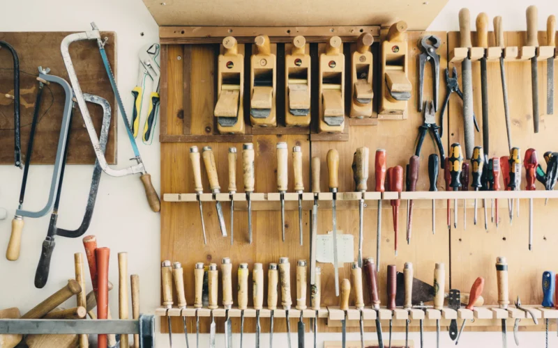 Assorted handheld tools in tool rack