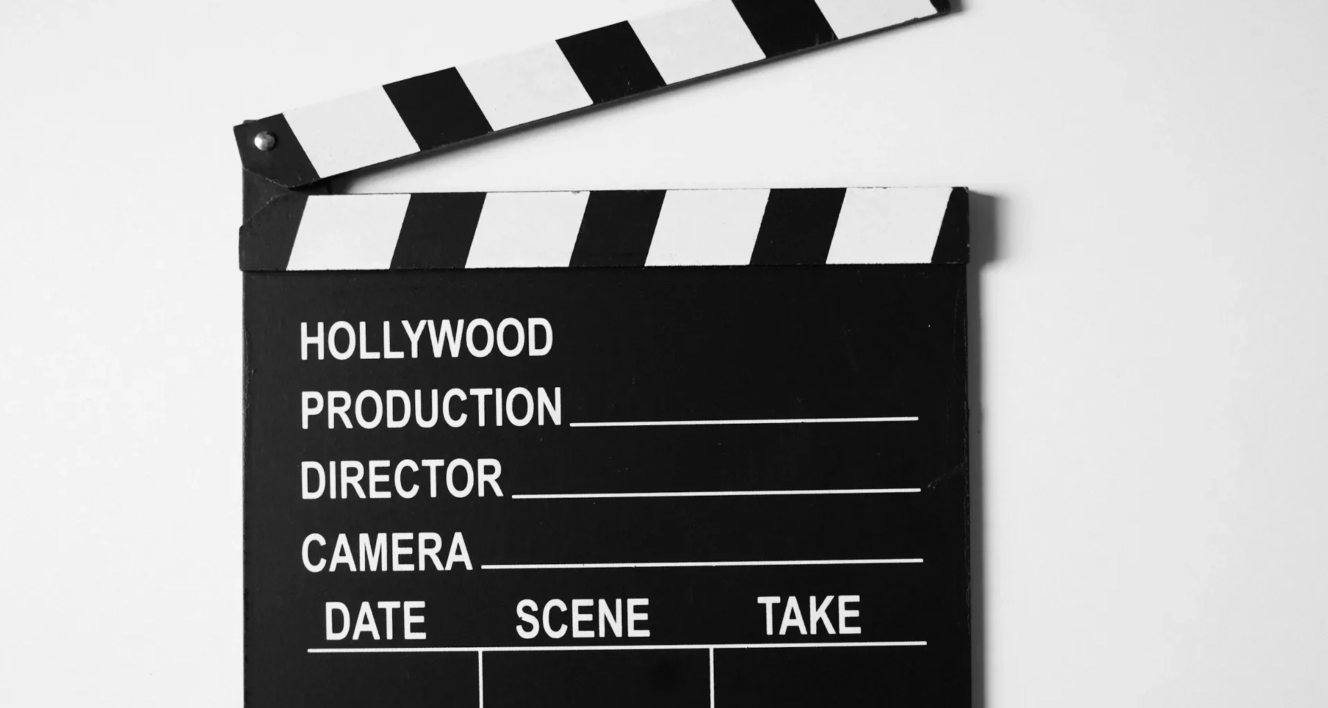 Black and white film clapperboard on a plain white background