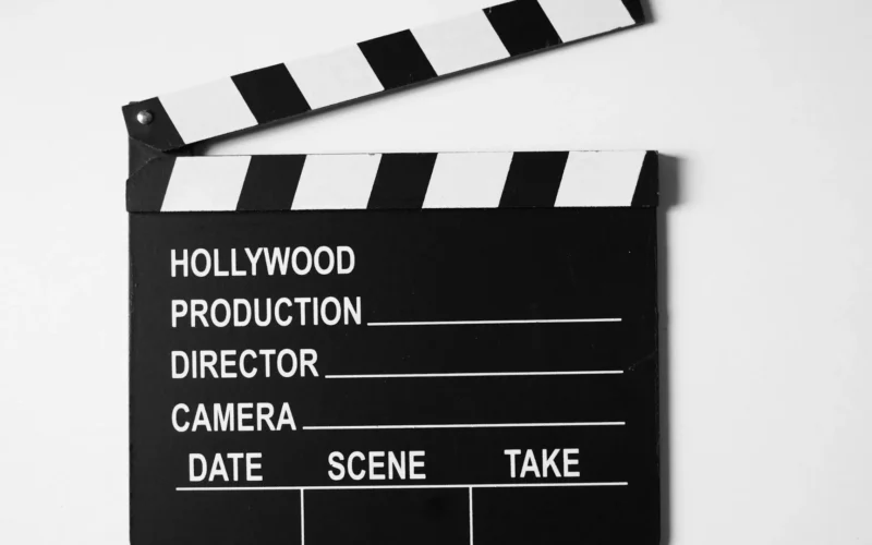 Black and white film clapperboard on a plain white background