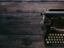 Black Corona typewriter on brown wood planks