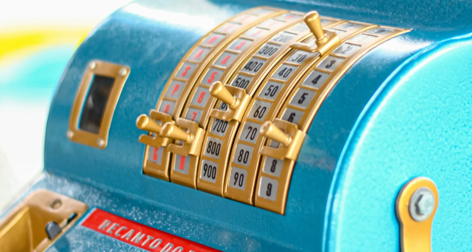 A blue cash register sitting on a shop counter