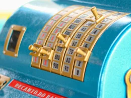 A blue cash register sitting on a shop counter