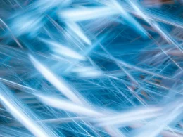 Pale blue light streaks crossing a dark blue background, an abstract image of compute time on a Canada EuroHPC link