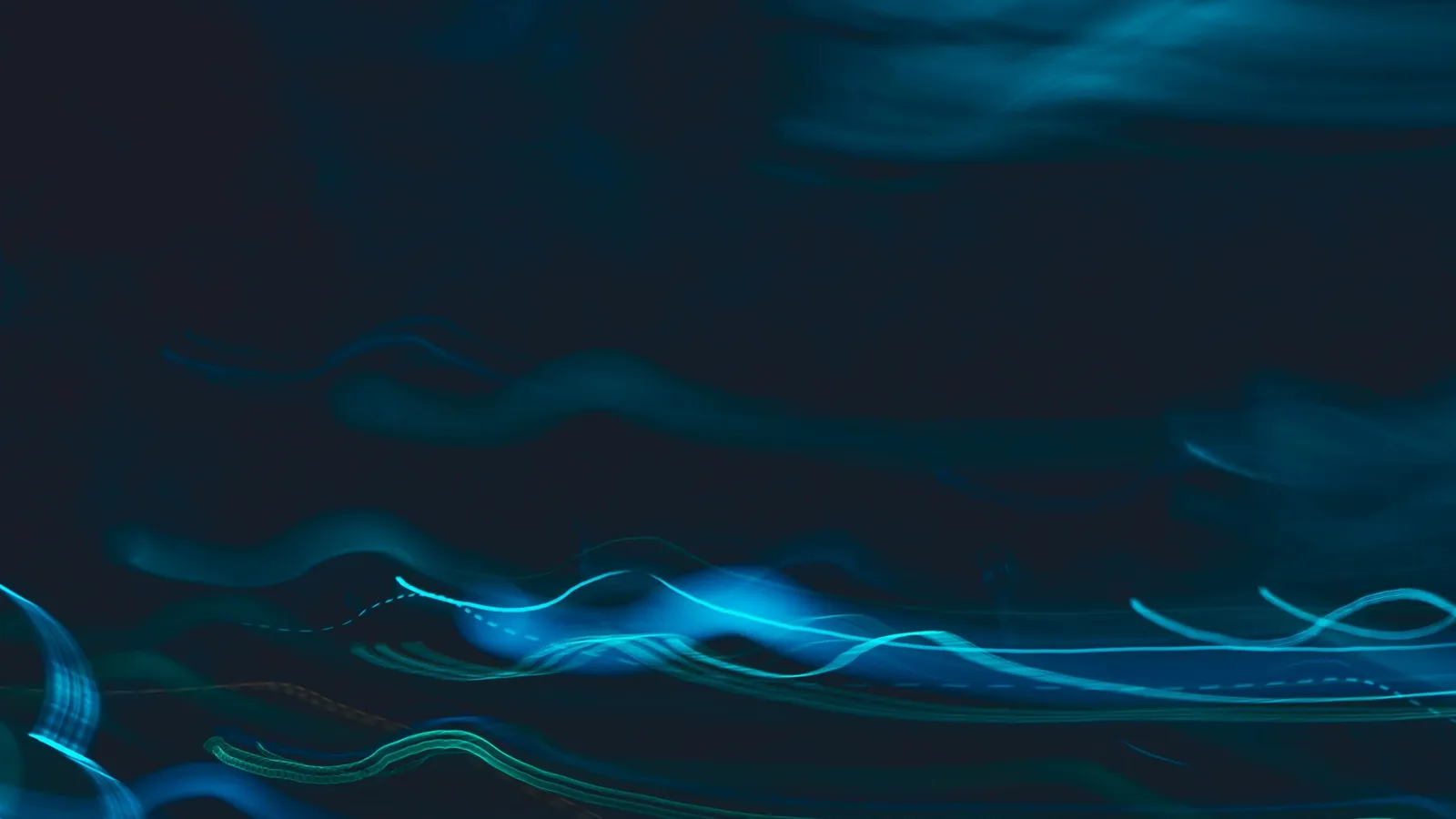 Blue light streaks curving across a dark background