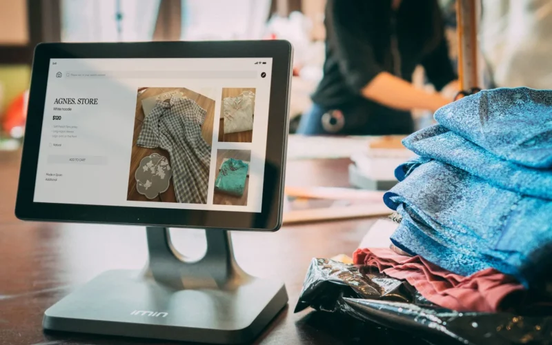Tablet point-of-sale screen in a small clothing shop, the kind of online store AI agent attacks went after
