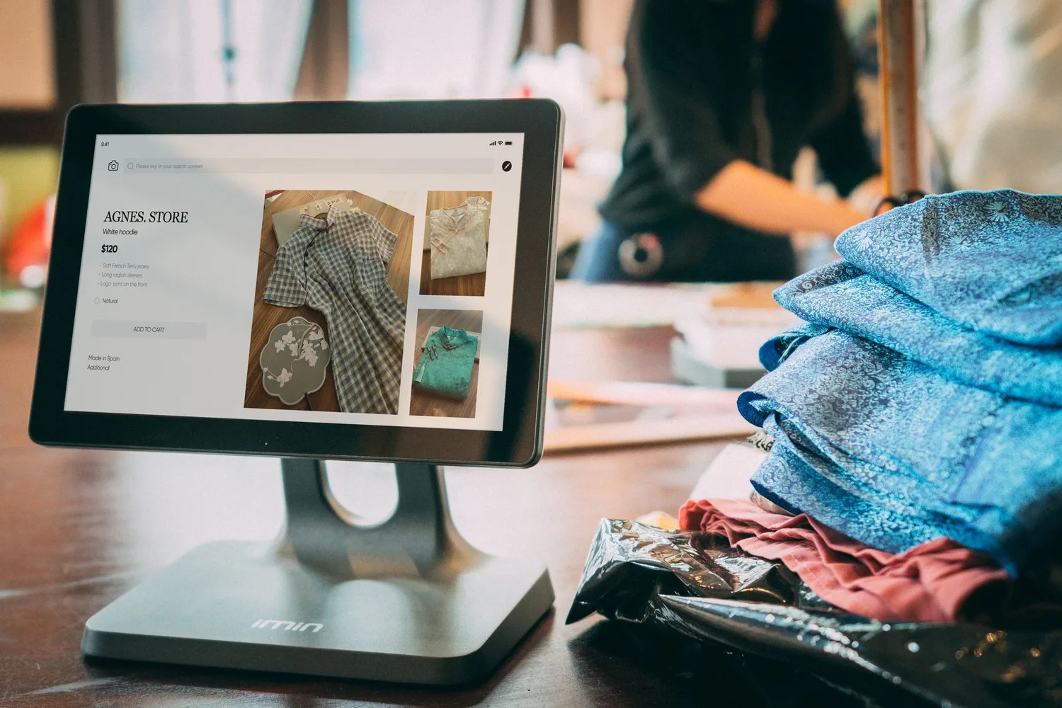 Tablet point-of-sale screen in a small clothing shop, the kind of online store AI agent attacks went after