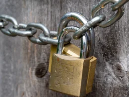 Brown padlock on brown wooden fence