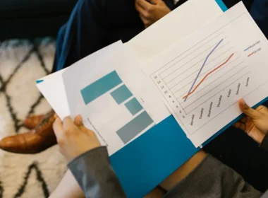 Printed business report with charts, like the Anthropic S-1 risk factors and financial tables