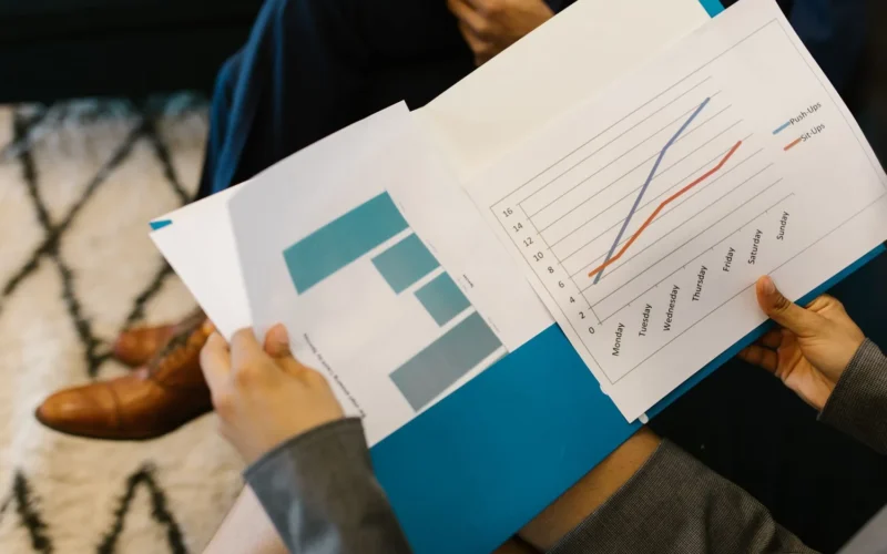 Printed business report with charts, like the Anthropic S-1 risk factors and financial tables