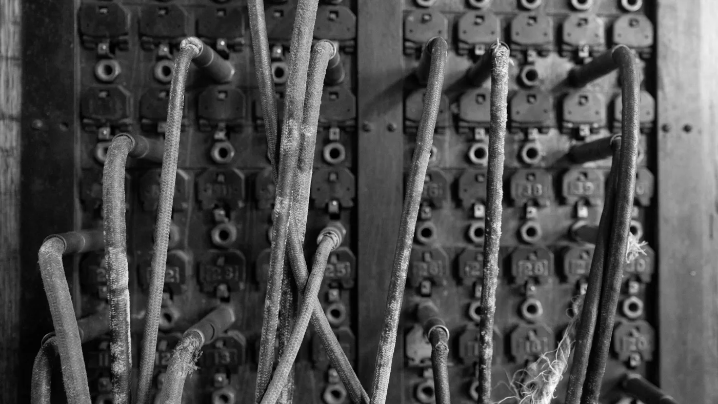 Old telephone switchboard with many wires