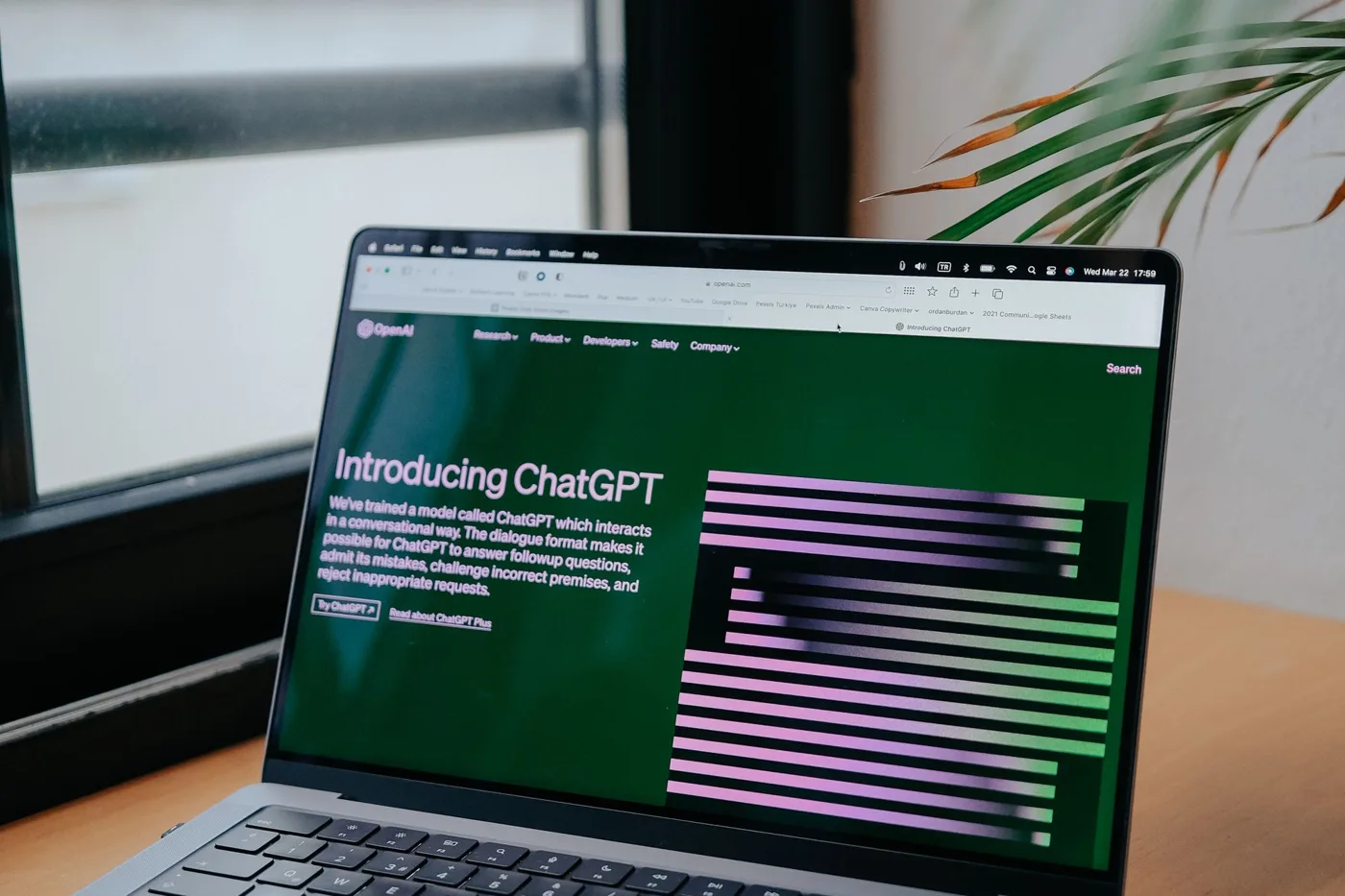 ChatGPT Pro plan cut: laptop on a desk by a window with the ChatGPT website open on screen.