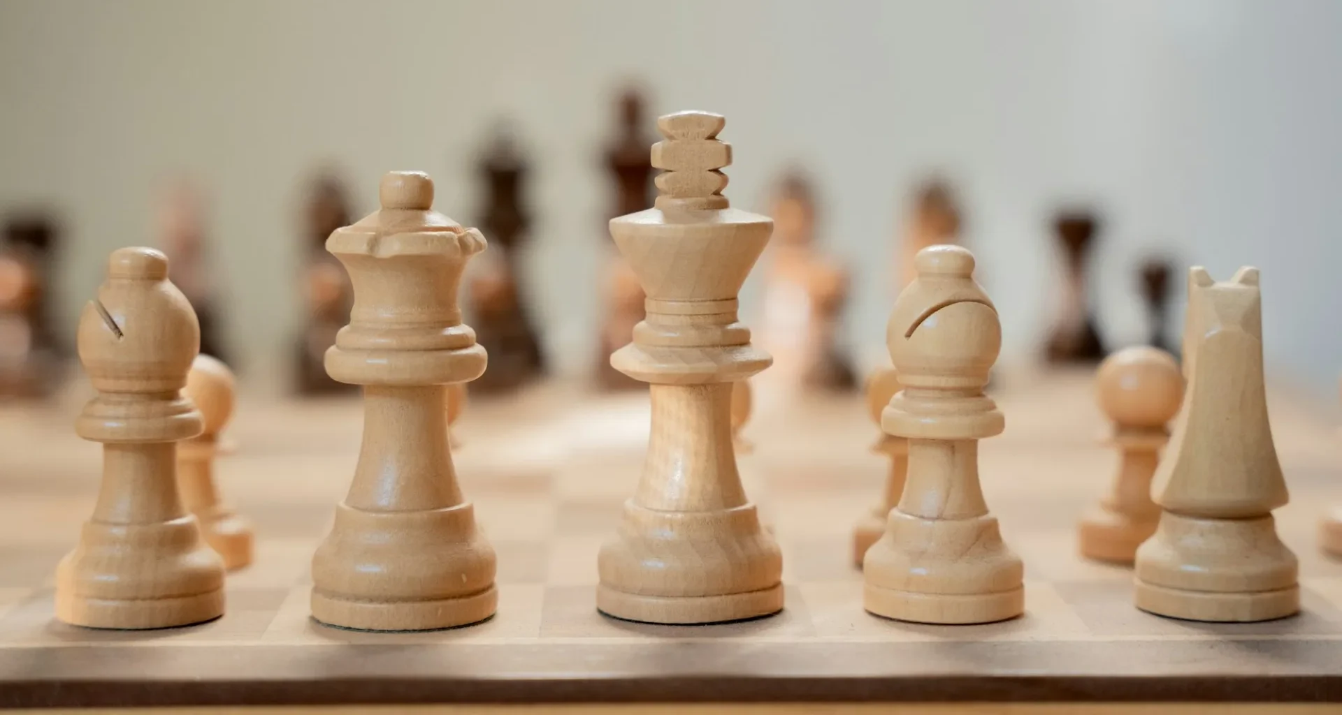 A close-up of a chess board with pieces mid-game