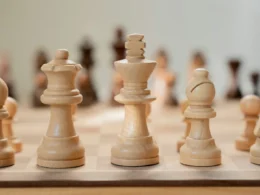 A close-up of a chess board with pieces mid-game