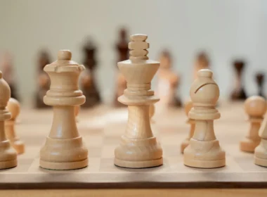 A close-up of a chess board with pieces mid-game