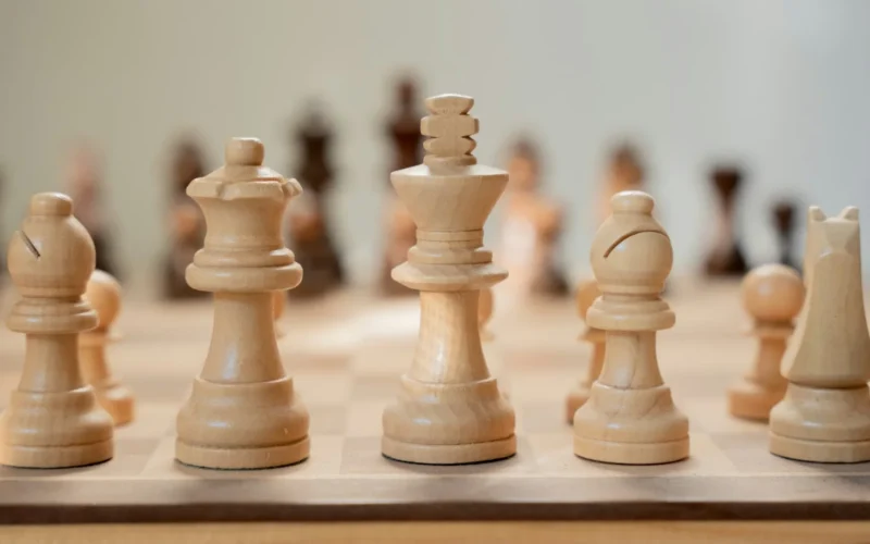 A close-up of a chess board with pieces mid-game
