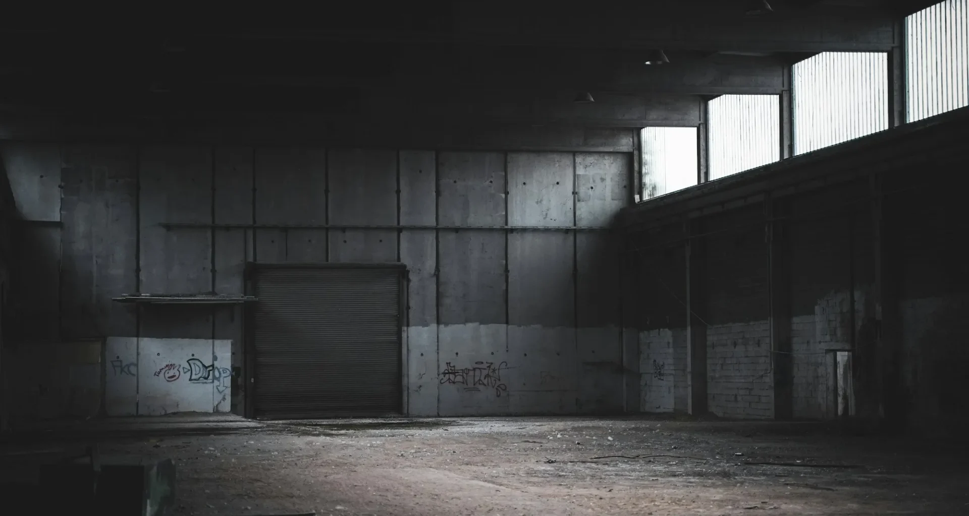 Empty building with a closed roller shutter.
