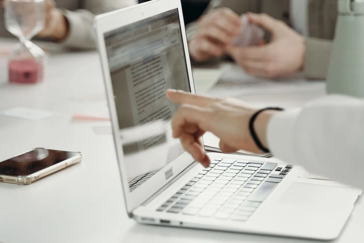 Muse Wonder pricing: colleagues reviewing results on a laptop.