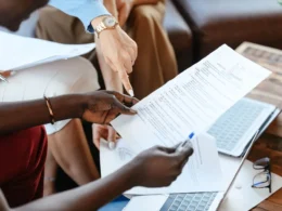 Colleagues checking documents together, the kind of AI agent output review that takes real staff time