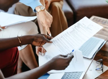 Colleagues checking documents together, the kind of AI agent output review that takes real staff time