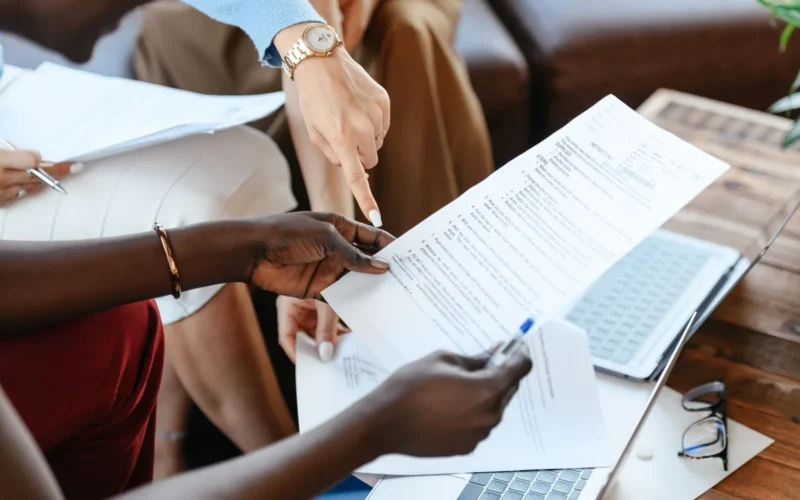 Colleagues checking documents together, the kind of AI agent output review that takes real staff time