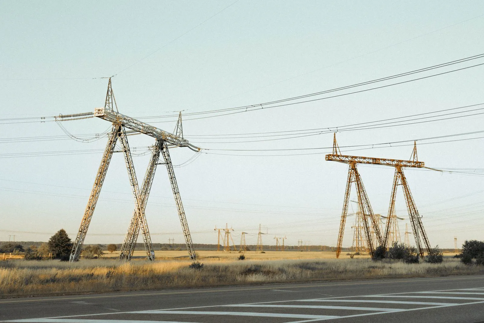 High voltage pylons beside a rural road, the grid connection at the centre of the Ontario data centre playbook